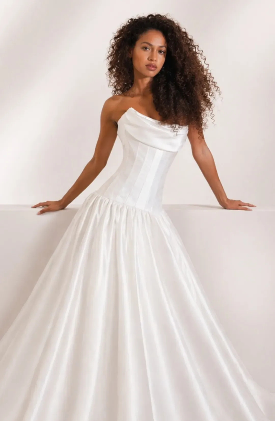 model is wearing a strapless drop waist bridal gown