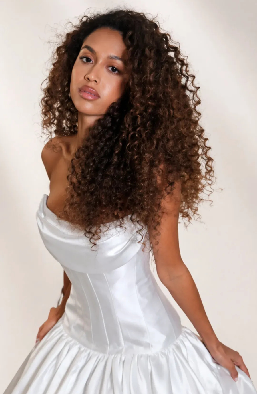model is wearing a strapless drop waist bridal gown