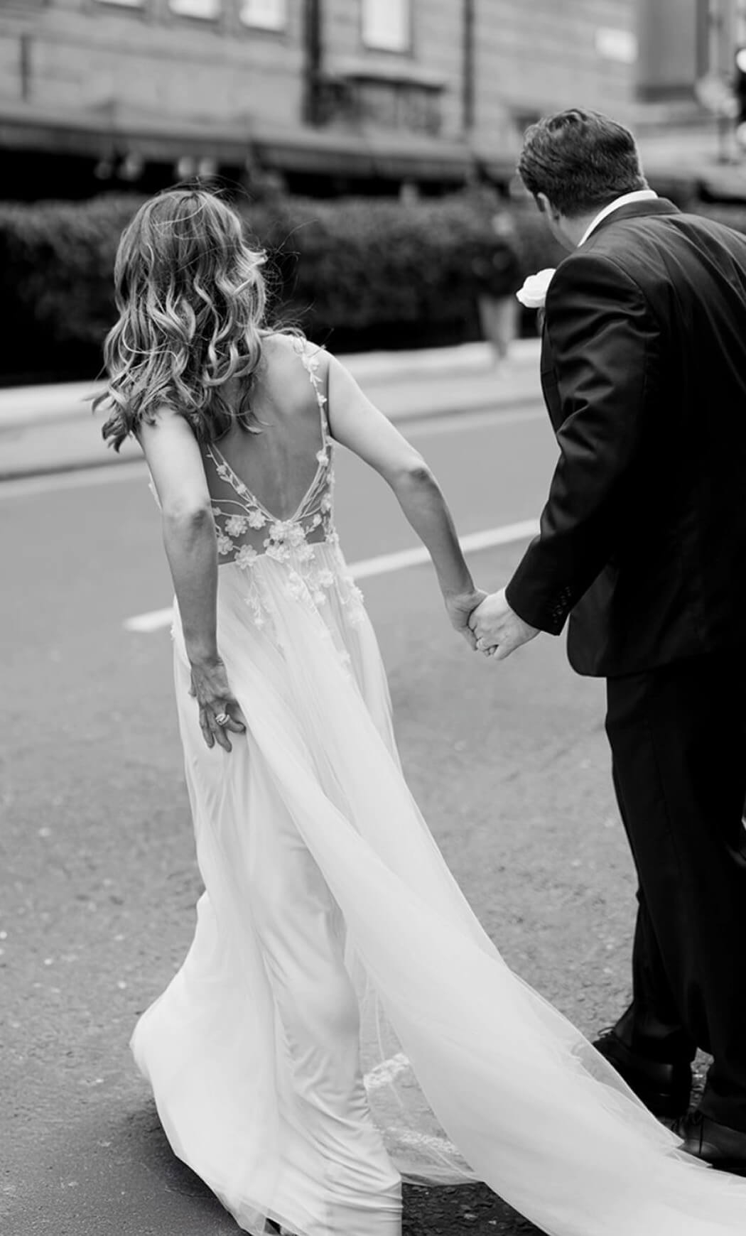 Сouple wearing a white gown and a black suit